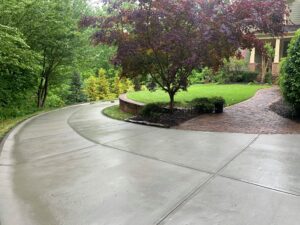 sloped concrete driveway on hill for house