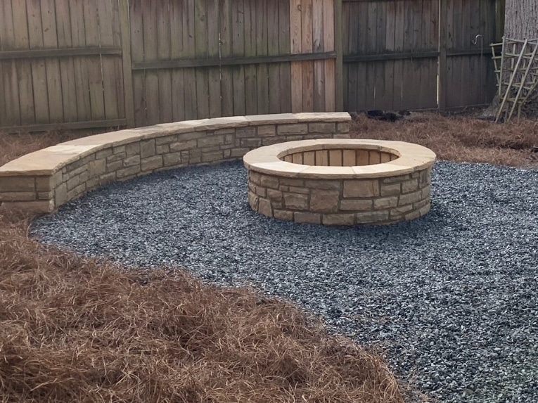 Stone firepit with masonry seating area