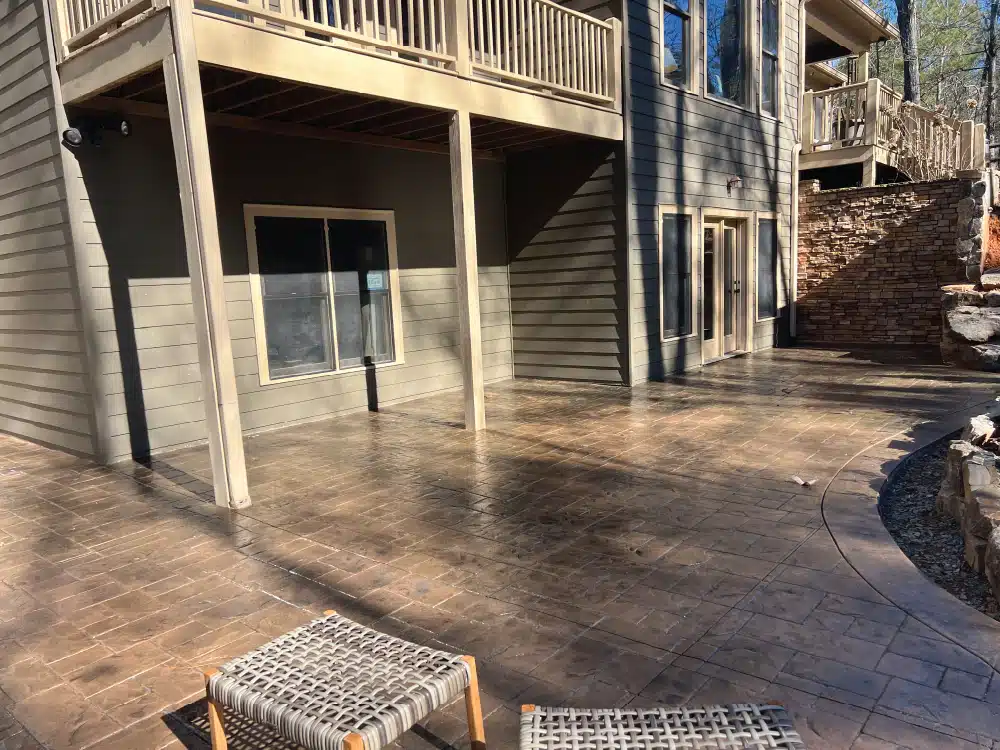 Relaxing outdoor space with bench and deck on stamped concrete.