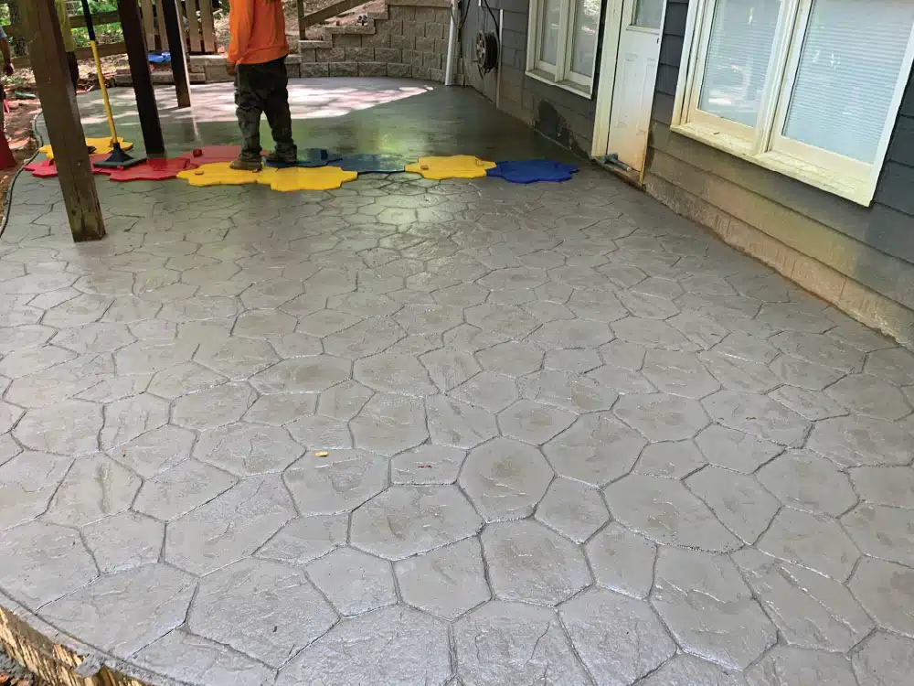 Decorative stamped concrete patio with a stone pattern, perfect for outdoor entertaining.