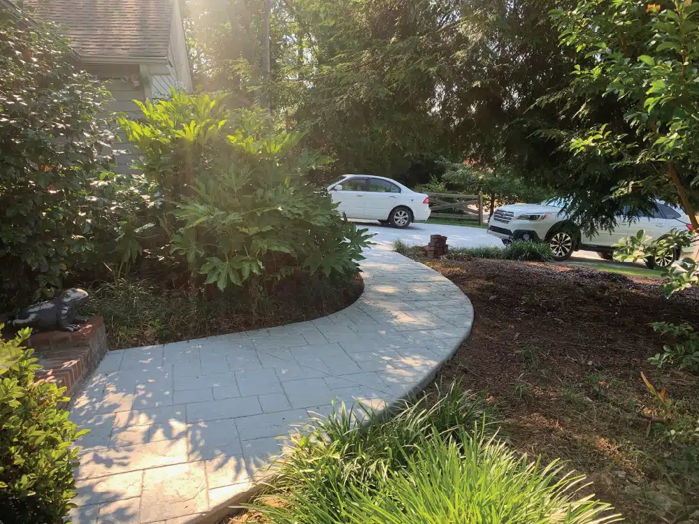 Textured stamped concrete walkway resembling natural stone.